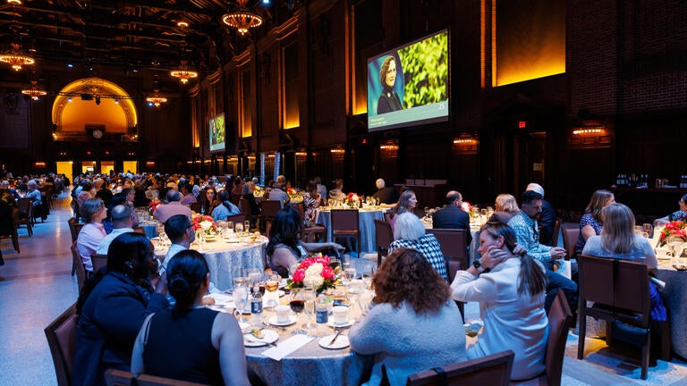 Guests enjoy dinner and the honoree slideshow featured on the jumbo screens.