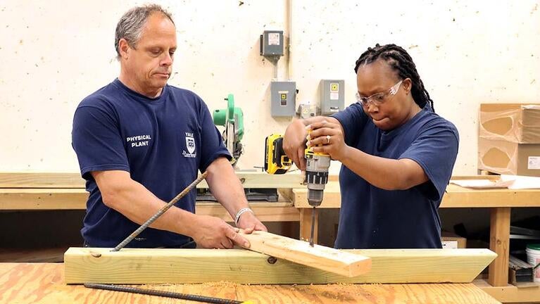 Carpenter Paul Cavaliere (left) working with apprentice Lakiya Gaye (right), photo by Ronnie Rysz