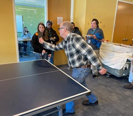 IT Staff playing ping-pong.