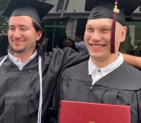 Sean Russell (right), son of Anna Atocha, University Properties, posed with his college roommate, Dave Tortora, on graduation day at Springfield College.