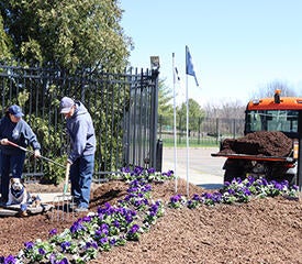 Dawn Landino and Louis "Louie" Scarini spreading mulch in flower beds at West Campus - Photo by Ronnie Rysz