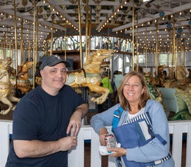 Photo of staff at the IT Community Picnic in front of a carousel.