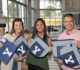 Photo of staff at the IT Community Picnic with Yale bags.