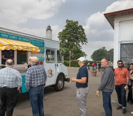 Photo of staff at the IT Community Picnic waiting in line for a food truck.