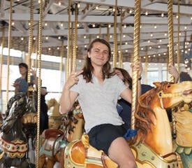 Photo of IT staff riding a carousel.