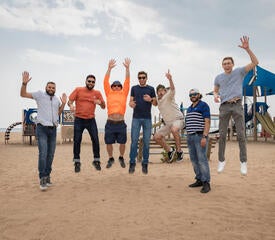 Photo of staff jumping at the IT Community Picnic