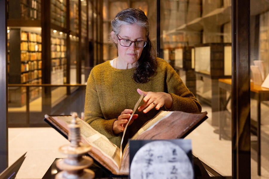 Person with Gutenberg Bible in library. Photos and video by Robert DeSanto.