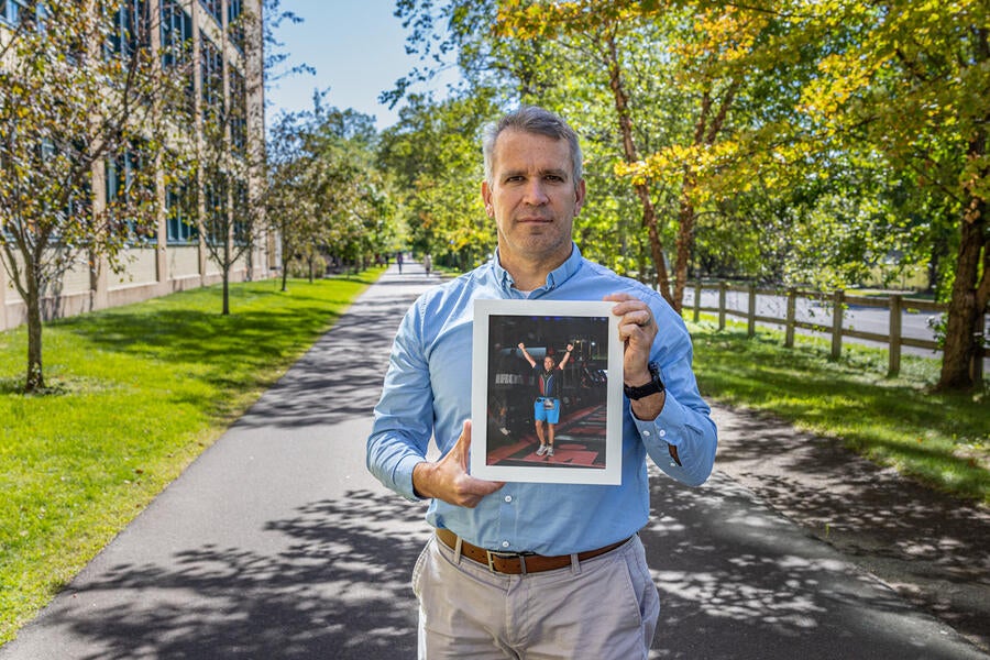 Michael van Emmenes holds a photo of his finish at the Ironman Lake Placid