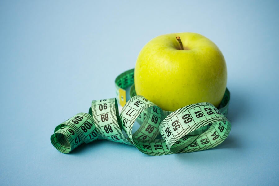 Image of apple and tape measure.