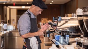 Yale Hospitality employee making a shot of espresso.