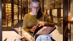 Person with Gutenberg Bible in library. Photos and video by Robert DeSanto.